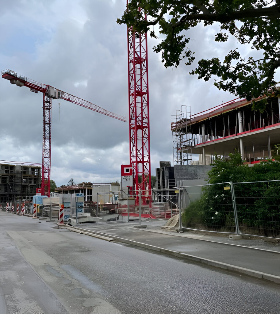 Baukran mit Rohbau – TEAMCONSTRUCT Hoch- und Industriebau